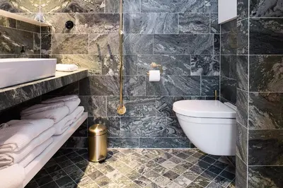 a bathroom with a white toilet and a sink at Spinoza Suites in Amsterdam