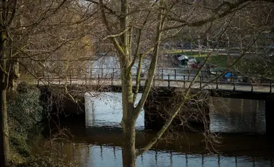 a bridge over a river with a dog on it at Spinoza Suites in Amsterdam