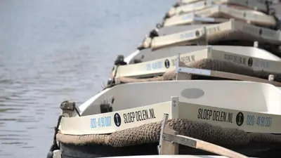 a row of boats lined up in the water at Spinoza Suites in Amsterdam