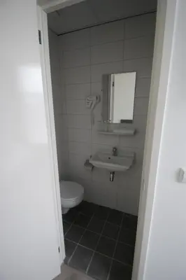 a bathroom with a toilet and a sink at Hotel de Keizerskroon Amsterdam-Schiphol-Halfweg in Halfweg