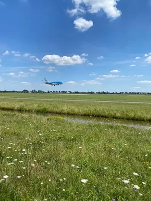 an airplane is taking off from a field with a runway at Hotel de Keizerskroon Amsterdam-Schiphol-Halfweg in Halfweg