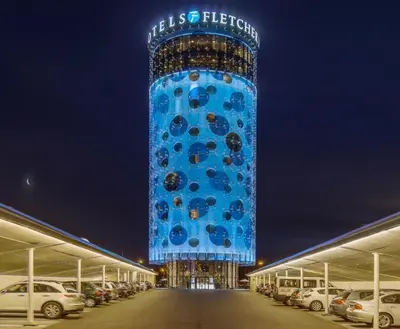 a tall blue tower with a building in the middle at Fletcher Hotel Amsterdam in Amsterdam