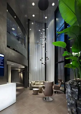 a lobby with a couch and a chair and a table at Fletcher Hotel Amsterdam in Amsterdam