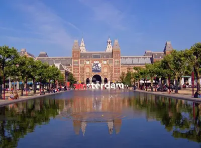 a large building with a pond in front of it at Fletcher Hotel Amsterdam in Amsterdam
