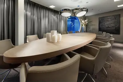 a conference room with a wooden table and chairs at Fletcher Hotel Amsterdam in Amsterdam