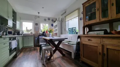 a kitchen with a table in the middle of it at City Farmer Amsterdam a Guesthouse with Bikes , Bed & Breakfast and Free Parking in Amsterdam