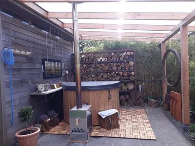 a hot tub in the middle of a patio at De Aagt Tuyn in Schoorl