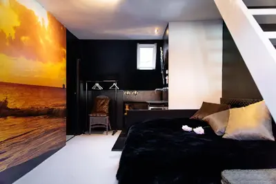 a bedroom with a black wall and a bed at Design B&B Naarden Vesting in Naarden