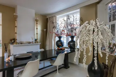 a dining room with vases and a table and chairs at Design B&B Naarden Vesting in Naarden