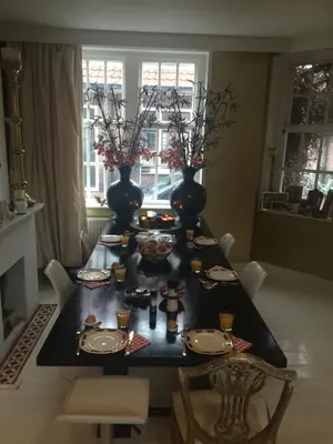 a black table with vases and plates on it at Design B&B Naarden Vesting in Naarden