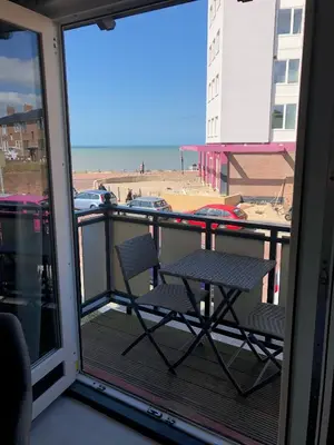 a balcony with two chairs and a view of a beach at By Simonis in Zandvoort