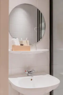 a bathroom with a sink and a mirror at Hotel Fita in Amsterdam