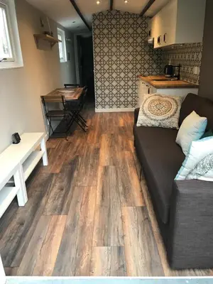 a living room with a couch and a table at Beach House Milou zandvoort Private Parking in Zandvoort