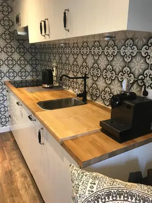 a kitchen counter with a sink and a microwave at Beach House Milou zandvoort Private Parking in Zandvoort