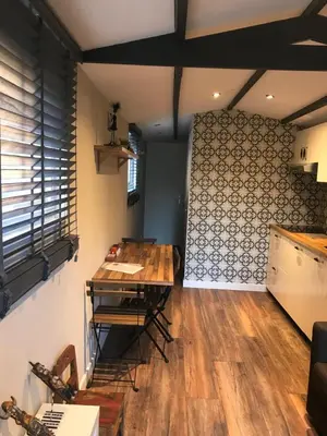 a dining room with a table and a wall at Beach House Milou zandvoort Private Parking in Zandvoort