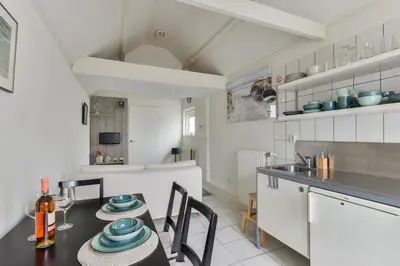 a kitchen and dining room with a table and chairs at Holiday Beach House in Zandvoort
