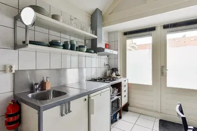a kitchen with a sink and a stove at Holiday Beach House in Zandvoort