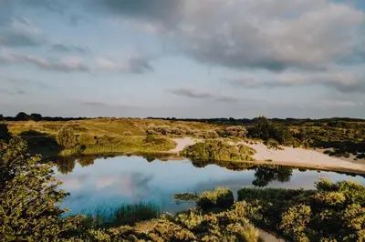 an aerial view of a lake in a field at BenSan Beach House in Zandvoort