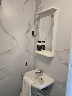 a bathroom with a sink and a mirror at BenSan Beach House in Zandvoort