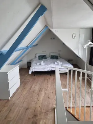 a bedroom with a bed in a attic at BenSan Beach House in Zandvoort