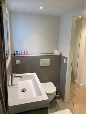 a bathroom with a white toilet and a sink at Kangaroom in Amsterdam