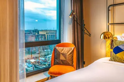 a hotel room with a bed and a window at Four Elements Hotel in Amsterdam