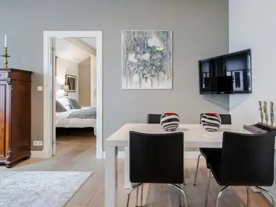 a living room with a white table and chairs at Palm Apartment Amsterdam in Amsterdam