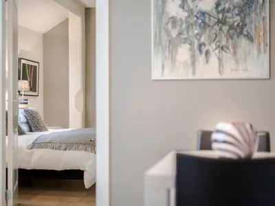 a bedroom with a bed and a painting on the wall at Palm Apartment Amsterdam in Amsterdam