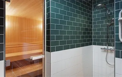 a bathroom with green tiles and a shower at Olympic Hotel in Amsterdam