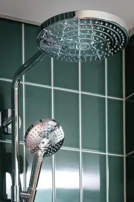 a shower head in a bathroom with a sink at Olympic Hotel in Amsterdam