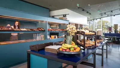 a bakery with a table with fruits and pastries at Olympic Hotel in Amsterdam