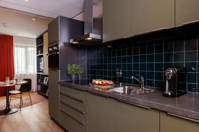 a kitchen with a sink and a counter top at Citadines Sloterdijk Station Amsterdam in Amsterdam