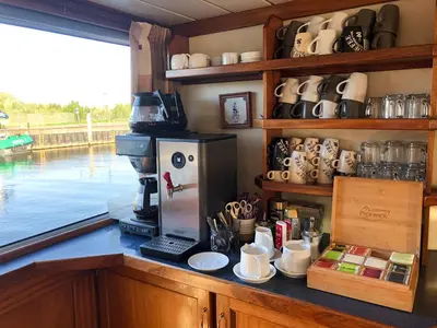 a kitchen with a counter with a coffee maker at Hotelboat Angeline in Amsterdam