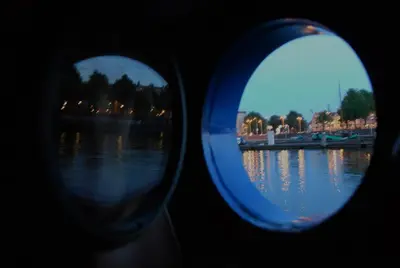 a view of a river through two glasses at Hotelboat Angeline in Amsterdam