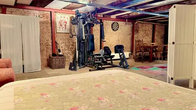 a room with a gym with a bed and exercise equipment at Top-notch apartment along canal in historic centre in Amsterdam