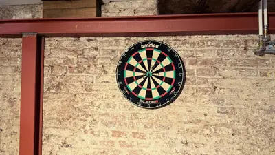 a dart board on the side of a brick wall at Top-notch apartment along canal in historic centre in Amsterdam