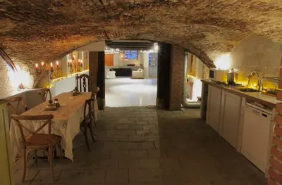 a kitchen and dining room with a table in a building at Top-notch apartment along canal in historic centre in Amsterdam