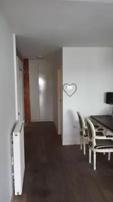 a dining room with chairs and a heart on the wall at 't Zandhuisje in Zandvoort