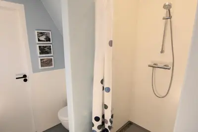 a bathroom with a shower and a toilet at Sailor Suite Coaster Mado in Amsterdam