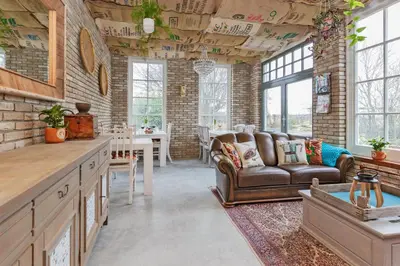 a living room with a couch and a table at Wellness Bed & Breakfast Pergamo in Voorhout