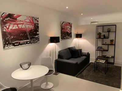 a living room with a couch and a table at Longhouse Studio Zandvoort in Zandvoort