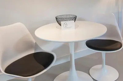 a white table with two chairs and a bowl on it at Longhouse Studio Zandvoort in Zandvoort