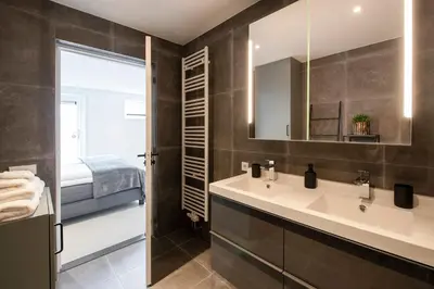 a bathroom with a sink and a mirror at Longhouse Studio Zandvoort in Zandvoort