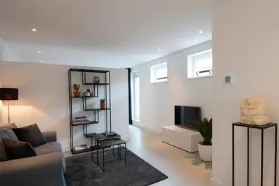 a living room with a couch and a tv at Longhouse Studio Zandvoort in Zandvoort