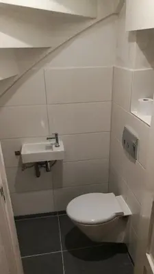 a bathroom with a toilet and a sink at Canal Garden Apartment StayWell Amsterdam in Amsterdam