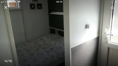 a small room with a small bed in a bedroom at Vakantiehuis Lara in Warmenhuizen