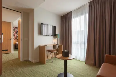 a hotel room with a desk and a window at Best Western Plus Amstelveen - Amsterdam in Amstelveen
