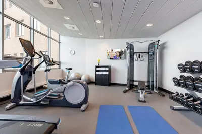 a gym with treadmills and exercise equipment in a room at Boutique Apartments Amsterdam in Amsterdam