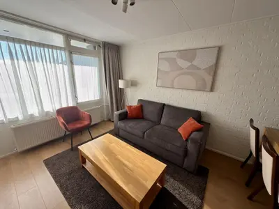 a living room with a couch and a table at Hotel Royal in Noordwijk