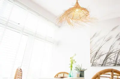 a dining room with a table and chairs and a window at Appartement Zuyd in Zandvoort